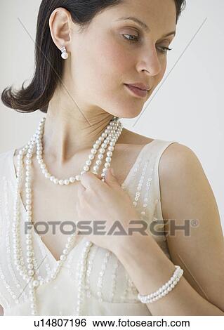 Woman wearing pearl jewelry View Large Photo Image Stock Photograph - Woman wearing pearl jewelry. Fotosearch