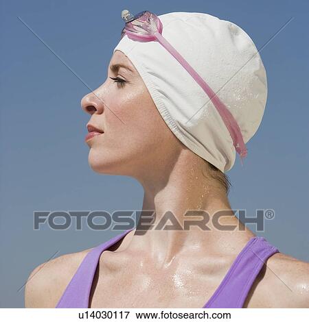 Woman wearing swimming cap and goggles View Large Photo Image Stock Photo - Woman wearing swimming cap and goggles. Fotosearch