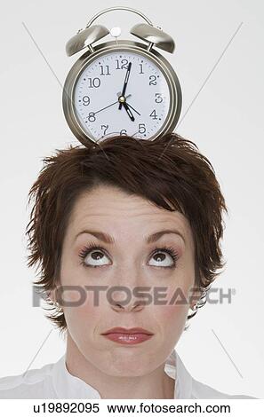 Woman with alarm clock on head View Large Photo Image Stock Photography - Woman with alarm clock on head. Fotosearch