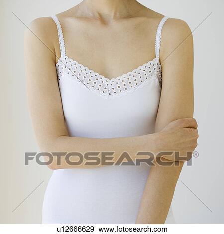 Stock Photo - Woman with arm crossed over torso. Fotosearch