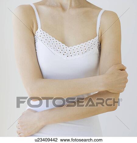 Woman with arms crossed over torso View Large Photo Image Stock Image - Woman with arms crossed over torso. Fotosearch