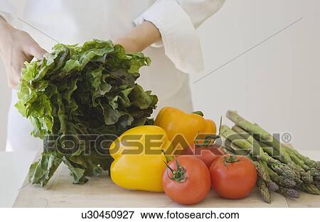 Stock Photo - Woman with fresh vegetables. Fotosearch