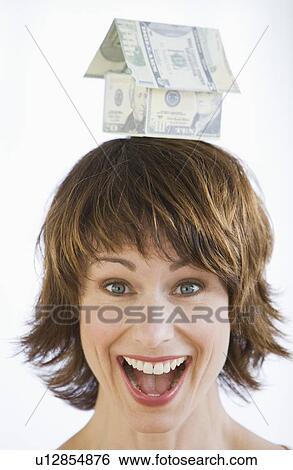 Woman with house made of money on head View Large Photo Image Stock Photograph - Woman with house made of money on head. Fotosearch