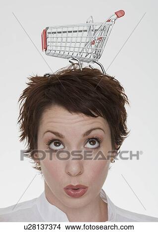 Woman with shopping cart on head View Large Photo Image Picture - Woman with shopping cart on head. Fotosearch