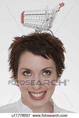 Stock Photo - Woman with shopping cart on head. Fotosearch