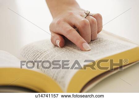 Woman's finger on page in Bible View Large Photo Image Stock Photo - Woman's finger on page in Bible. Fotosearch