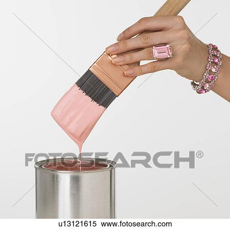 Woman's jeweled hand dipping paintbrush in paint can View Large Photo Image Stock Photography - Woman's jeweled hand dipping paintbrush in paint can. Fotosearch
