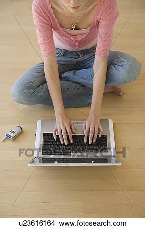 Young woman typing on laptop View Large Photo Image Picture - Young woman typing on laptop. Fotosearch