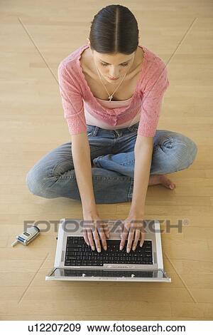 Young woman typing on laptop View Large Photo Image Stock Photo - Young woman typing on laptop. Fotosearch