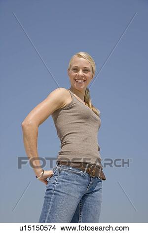 Young woman with hand in back pocket View Large Photo Image Picture - Young woman with hand in back pocket. Fotosearch