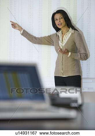 Stock Photo - African businesswoman giving presentation. Fotosearch