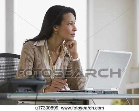 African businesswoman next to laptop View Large Photo Image Stock Photo - African businesswoman next to laptop. Fotosearch