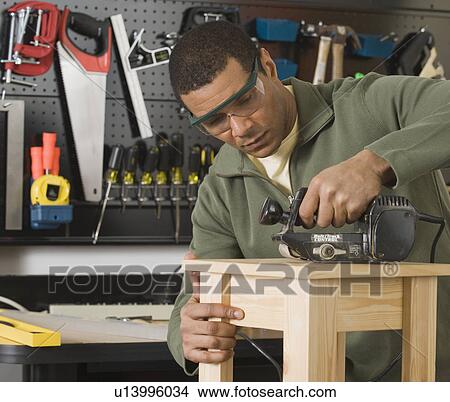 African male woodworker sanding table View Large Photo Image Picture - African male woodworker sanding table. Fotosearch
