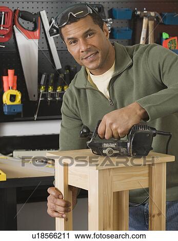 African male woodworker sanding table View Large Photo Image Stock Image - African male woodworker sanding table. Fotosearch