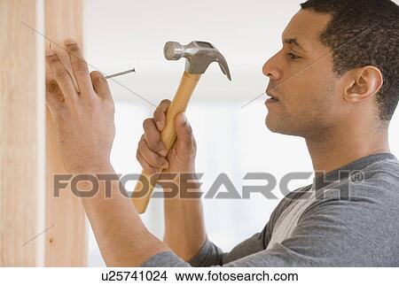 African man hammering nail View Large Photo Image Picture - African man hammering nail. Fotosearch