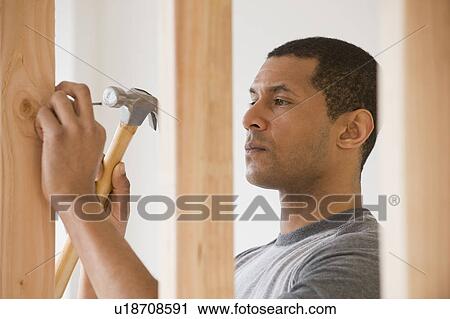 African man hammering nail View Large Photo Image Stock Image - African man hammering nail. Fotosearch