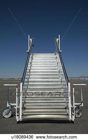 Stock Photograph - Airplane staircase on tarmac. Fotosearch