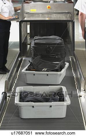 Airport security worker checking baggage View Large Photo Image Stock Image - Airport security worker checking baggage. Fotosearch