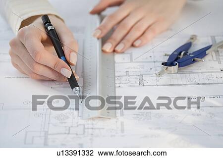 Architect drawing on blueprints View Large Photo Image Stock Image - Architect drawing on blueprints. Fotosearch