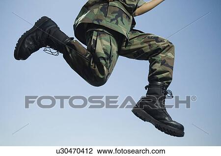 Stock Image - Army soldier jumping. Fotosearch