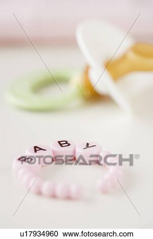 Stock Image - Baby bracelet and pacifier. Fotosearch