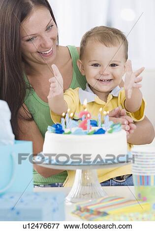 Stock Photo - Baby celebrating birthday with mother. Fotosearch