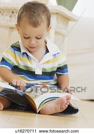 Baby looking at book View Large Photo Image Stock Image - Baby looking at book. Fotosearch