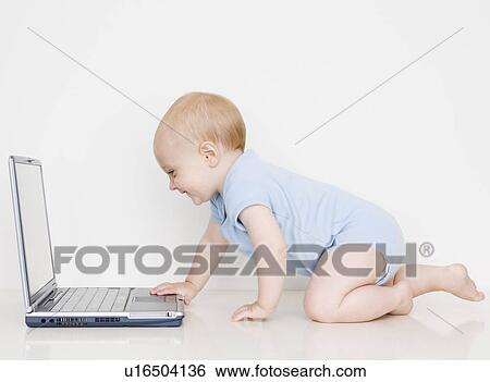 Baby looking at laptop View Large Photo Image Stock Photograph - Baby looking at laptop. Fotosearch