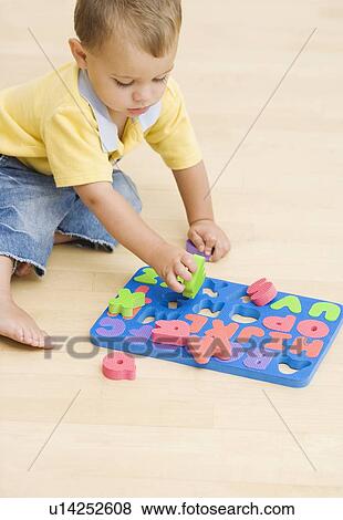 Baby playing with foam letters View Large Photo Image Stock Photo - Baby playing with foam letters. Fotosearch