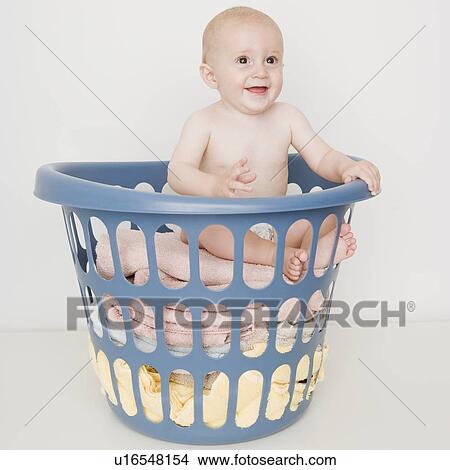 Baby sitting in laundry basket View Large Photo Image Picture - Baby sitting in laundry basket. Fotosearch