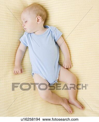Baby sleeping on bed View Large Photo Image Picture - Baby sleeping on bed. Fotosearch