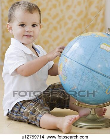 Baby touching globe View Large Photo Image Picture - Baby touching globe. Fotosearch