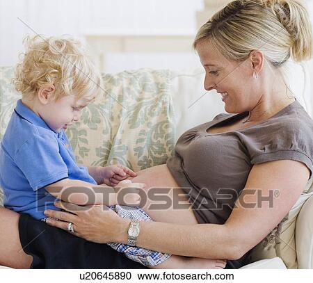 Baby touching mother’s pregnant belly View Large Photo Image Stock Image - Baby touching mother’s pregnant belly. Fotosearch