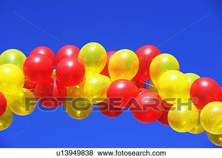 Balloon arch under blue sky View Large Photo Image Stock Photo - Balloon arch under blue sky. Fotosearch