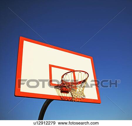Stock Photo - Basketball hoop under blue sky. Fotosearch