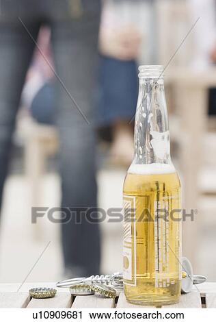 Beer bottle on table View Large Photo Image Stock Image - Beer bottle on table. Fotosearch