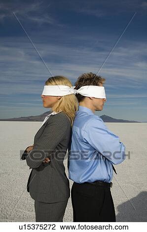 Blindfolded businesspeople standing back to back, Salt Flats, Utah, United States View Large Photo Image Stock Image - Blindfolded businesspeople standing back to back, Salt Flats, Utah, United States. Fotosearch