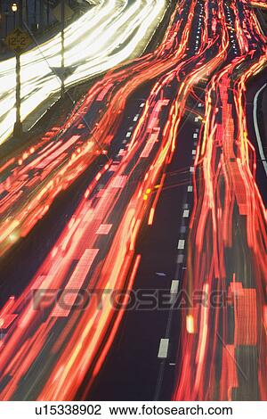 Stock Image - Blurred motion shot of traffic on large highway. Fotosearch