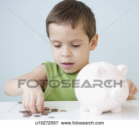 Boy counting coins from piggy bank View Large Photo Image Stock Photo - Boy counting coins from piggy bank. Fotosearch