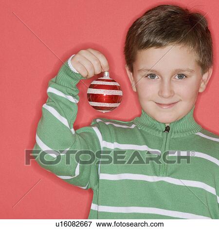 Boy holding Christmas ornament View Large Photo Image Stock Photo - Boy holding Christmas ornament. Fotosearch