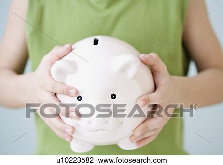 Boy holding piggy bank View Large Photo Image Stock Image - Boy holding piggy bank. Fotosearch