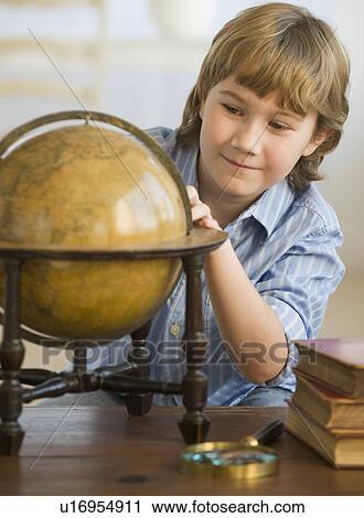 Boy looking at globe View Large Photo Image Stock Image - Boy looking at globe. Fotosearch