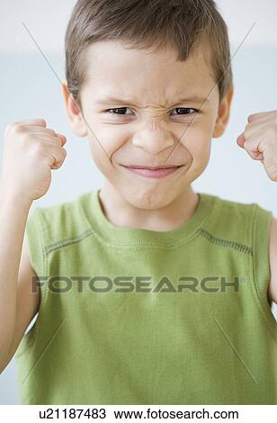 Boy making a face and clenching fists View Large Photo Image Stock Image - Boy making a face and clenching fists. Fotosearch