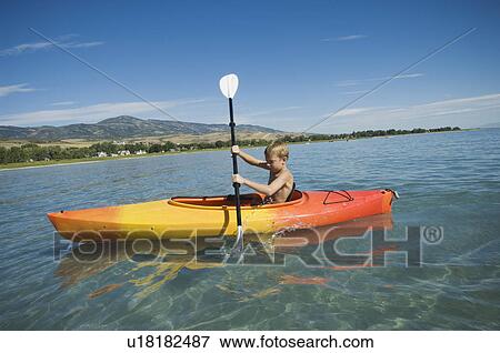 Boy paddling in canoe on lake, Utah, United States View Large Photo Image Stock Photo - Boy paddling in canoe on lake, Utah, United States. Fotosearch