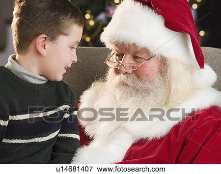 Boy sitting on Santa Claus’s lap View Large Photo Image Stock Photo - Boy sitting on Santa Claus’s lap. Fotosearch