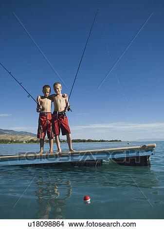 Picture - Brothers fishing off dock in lake, Utah, United States. Fotosearch