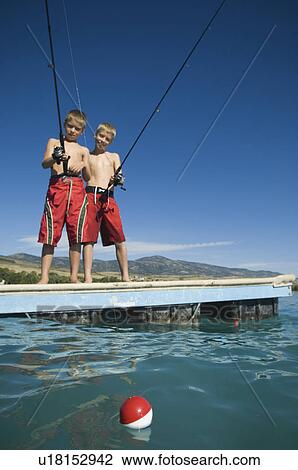 Brothers fishing off dock in lake, Utah, United States View Large Photo Image Stock Image - Brothers fishing off dock in lake, Utah, United States. Fotosearch