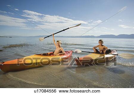 Brothers paddling in canoes on lake, Utah, United States View Large Photo Image Stock Photograph - Brothers paddling in canoes on lake, Utah, United States. Fotosearch