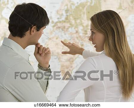 Picture - Business people looking at world map. Fotosearch