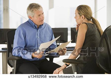Businessman and businesswoman talking View Large Photo Image Stock Photo - Businessman and businesswoman talking. Fotosearch